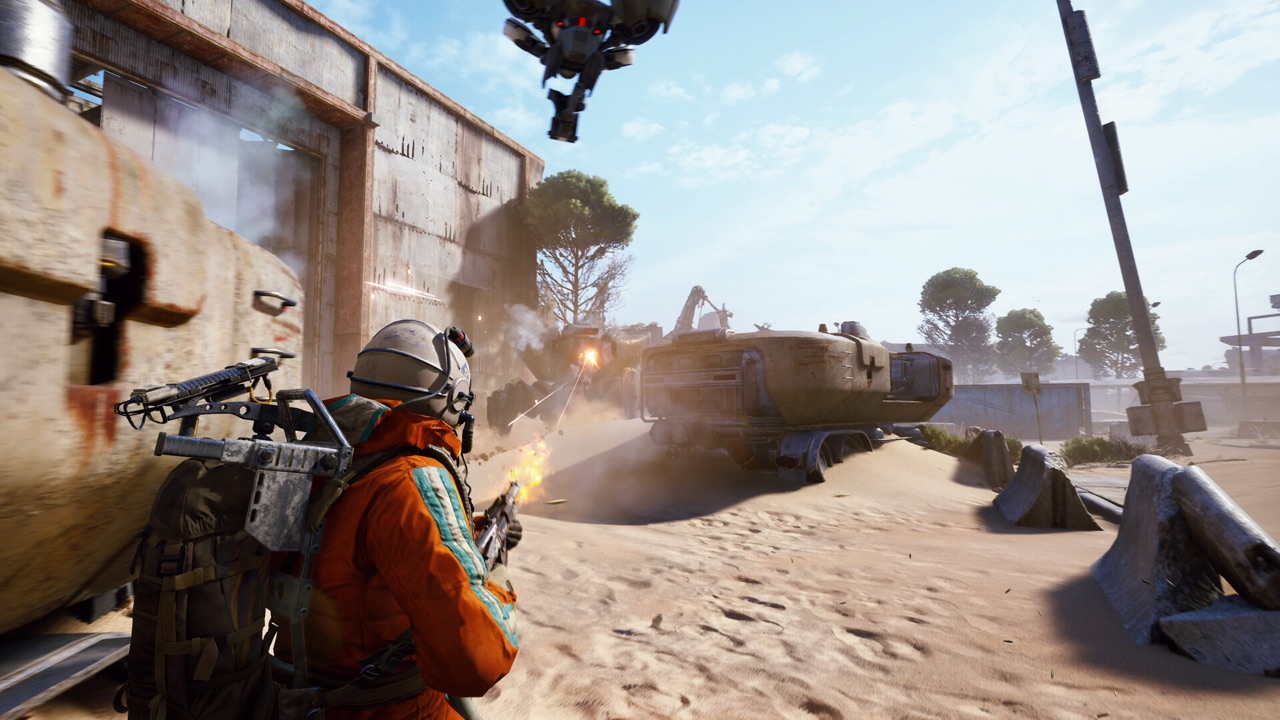A raider in an orange suit firing on an armored ARC vehicle amid sunbaked desert ruins in Arc Raiders