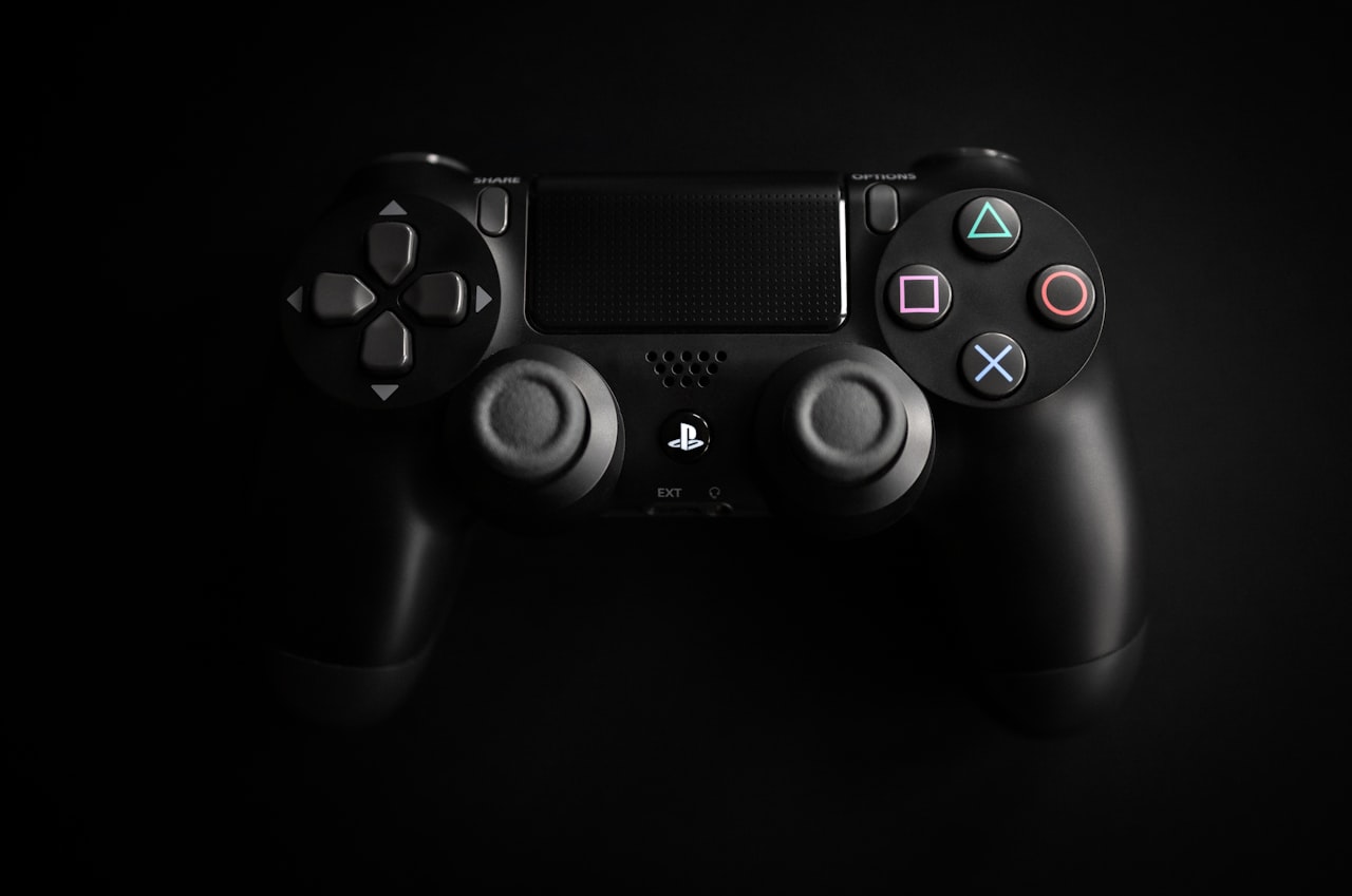 PlayStation DualShock controller photographed dramatically against a dark background