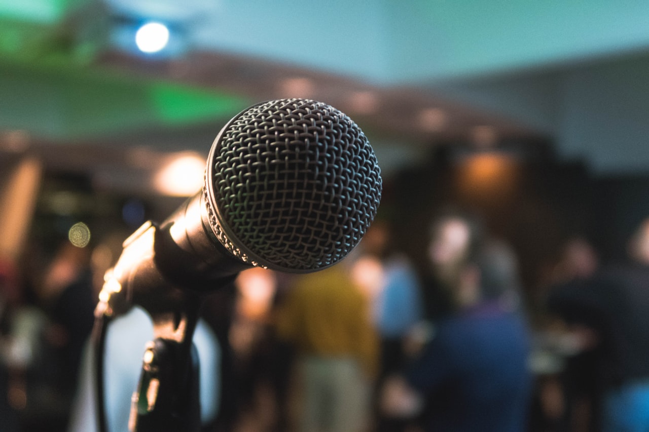 A GDC developer panel discussion with speakers at a podium โ sessions like this at GDC 2026 surfaced data showing negative AI sentiment among developers has nearly tripled in two years