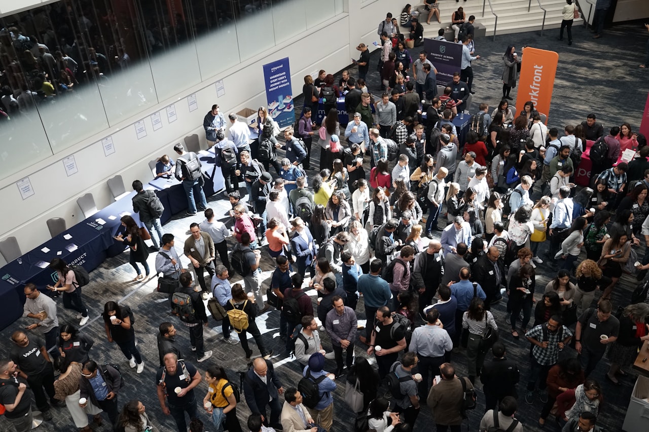 Overhead view of a crowded convention floor with thousands of industry professionals networking