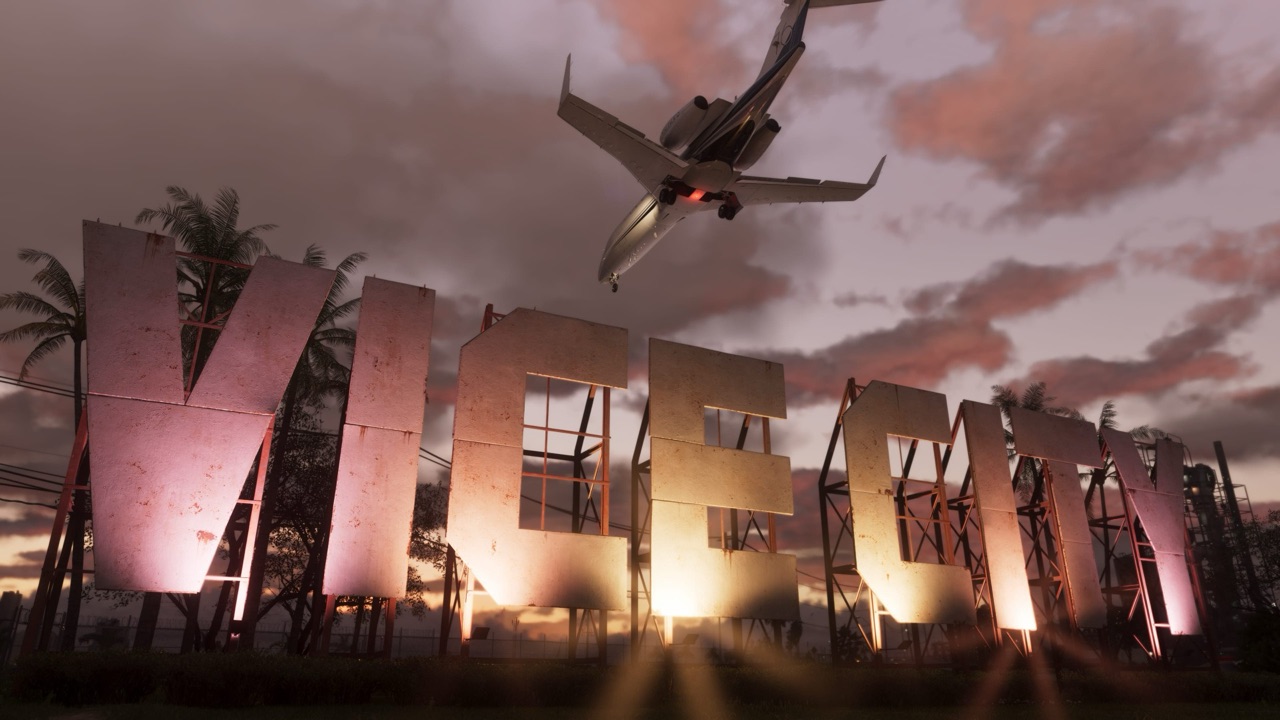 The weathered VICE CITY sign lit from below at dusk in Grand Theft Auto VI, with a private jet passing low overhead and palm trees silhouetted against a pink sky
