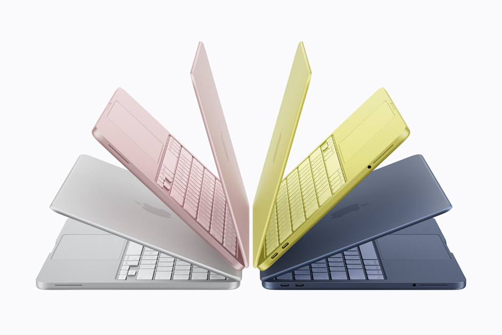 The MacBook Neo lineup in all four colors — silver, blush, citrus, and indigo — fanned out to show the color-matched keyboards and slim aluminum bodies