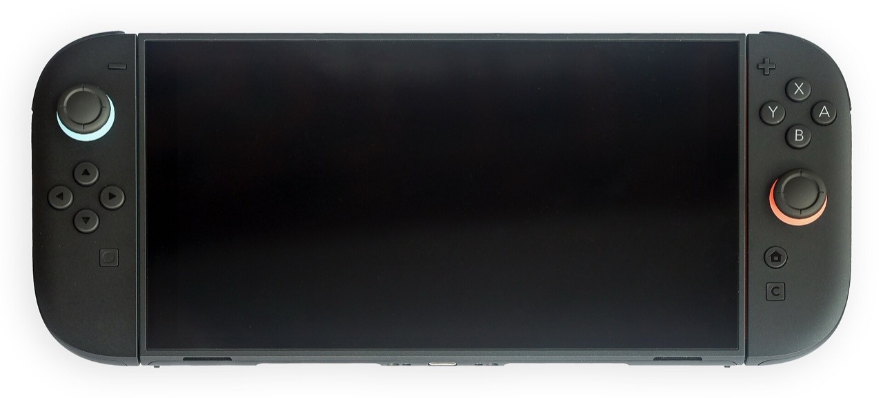 A Nintendo Switch 2 held in handheld mode, both Joy-Con attached, screen lit and facing the camera
