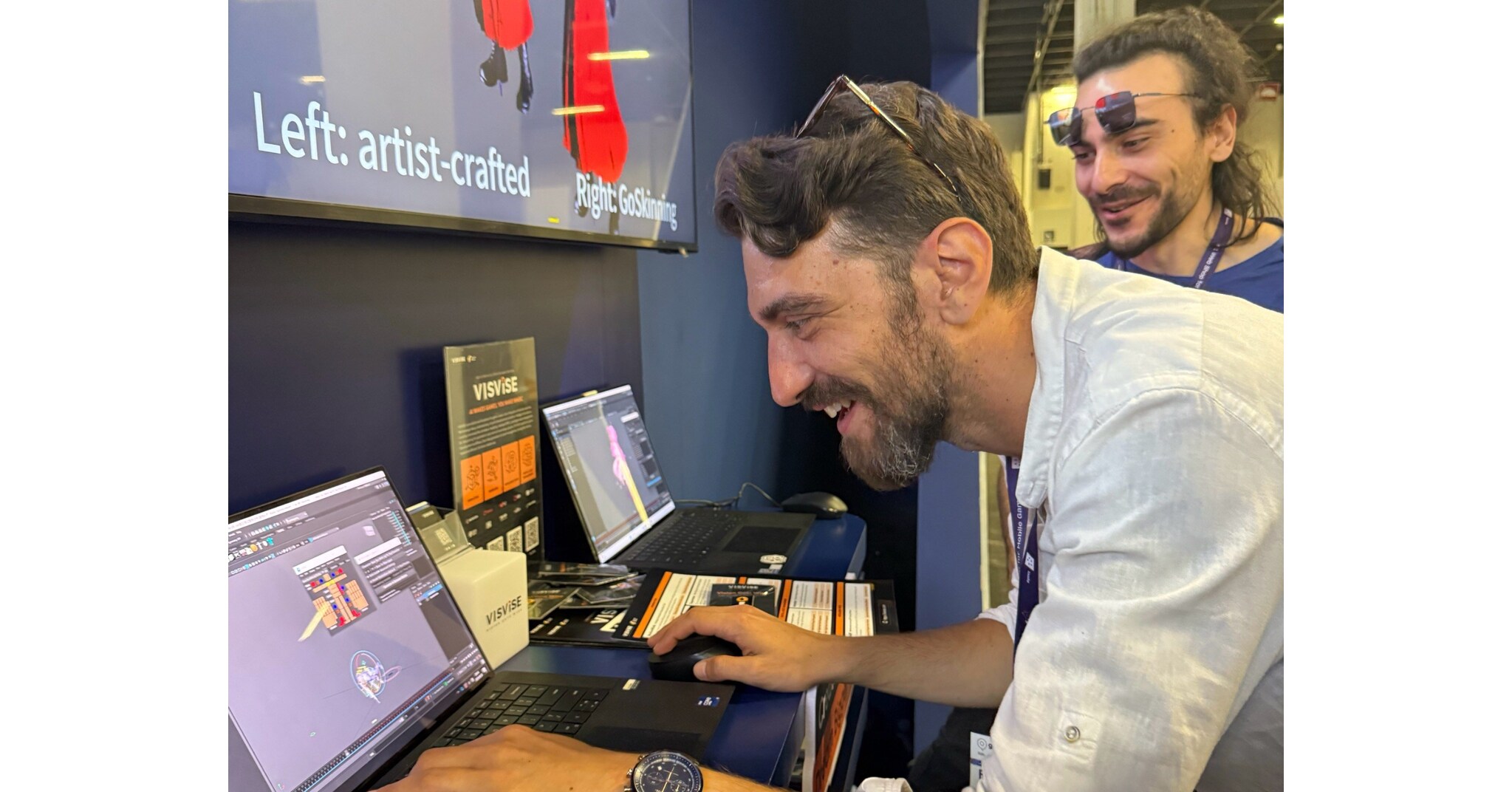 Developers trying out VISVISE demos at the booth, comparing artist-crafted work with GoSkinning AI-generated results side by side