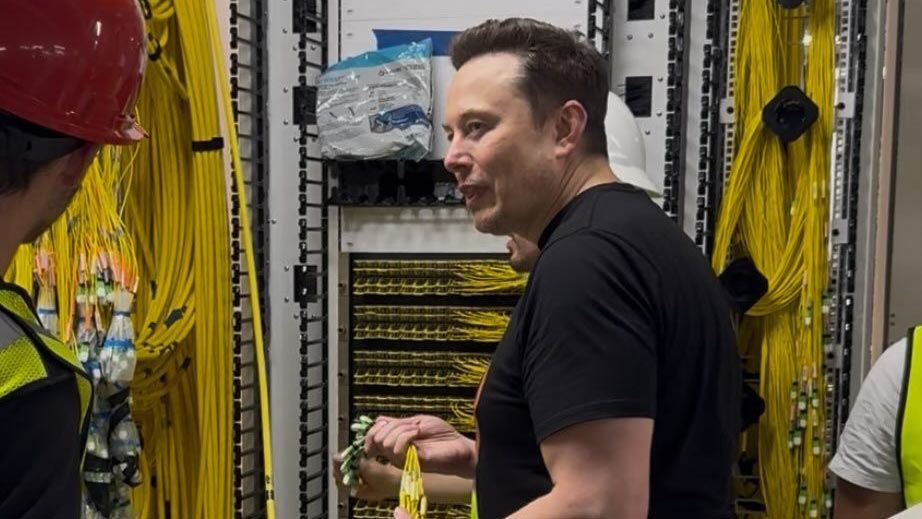 Elon Musk at xAI's Colossus data center in Memphis, surrounded by server infrastructure powering the company's AI ambitions